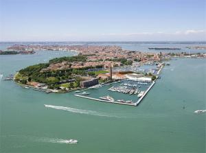 Venice - aerial view looking west. Public gardens in the foreground. Giudecca Island to the left. San Marco and Bell Tower in the distance, slightly to the left of centre.
