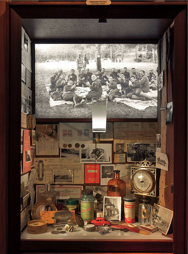 This display case shows the elements of life that invoke memories, photos, medicines, toys...