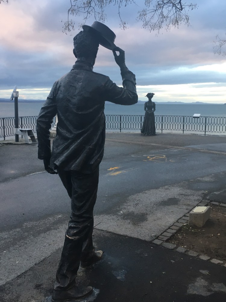 Neuchatel, Switzerland - a lady takes the air on the Promenade. c. 1840 - a passing gentleman raises his hat in greeting.