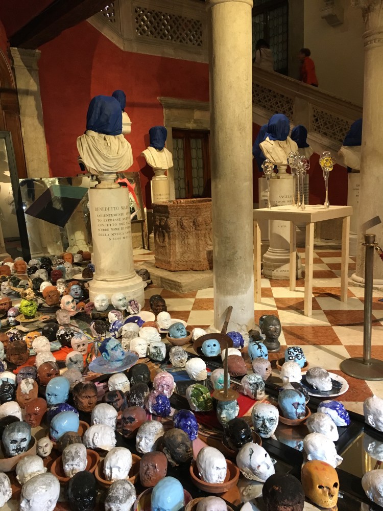 Palazzo Loredan - portrait busts covered by Cuban artist Carlos Quintana - with numerous glass and plaster skulls at their feet - Biennale, 2019