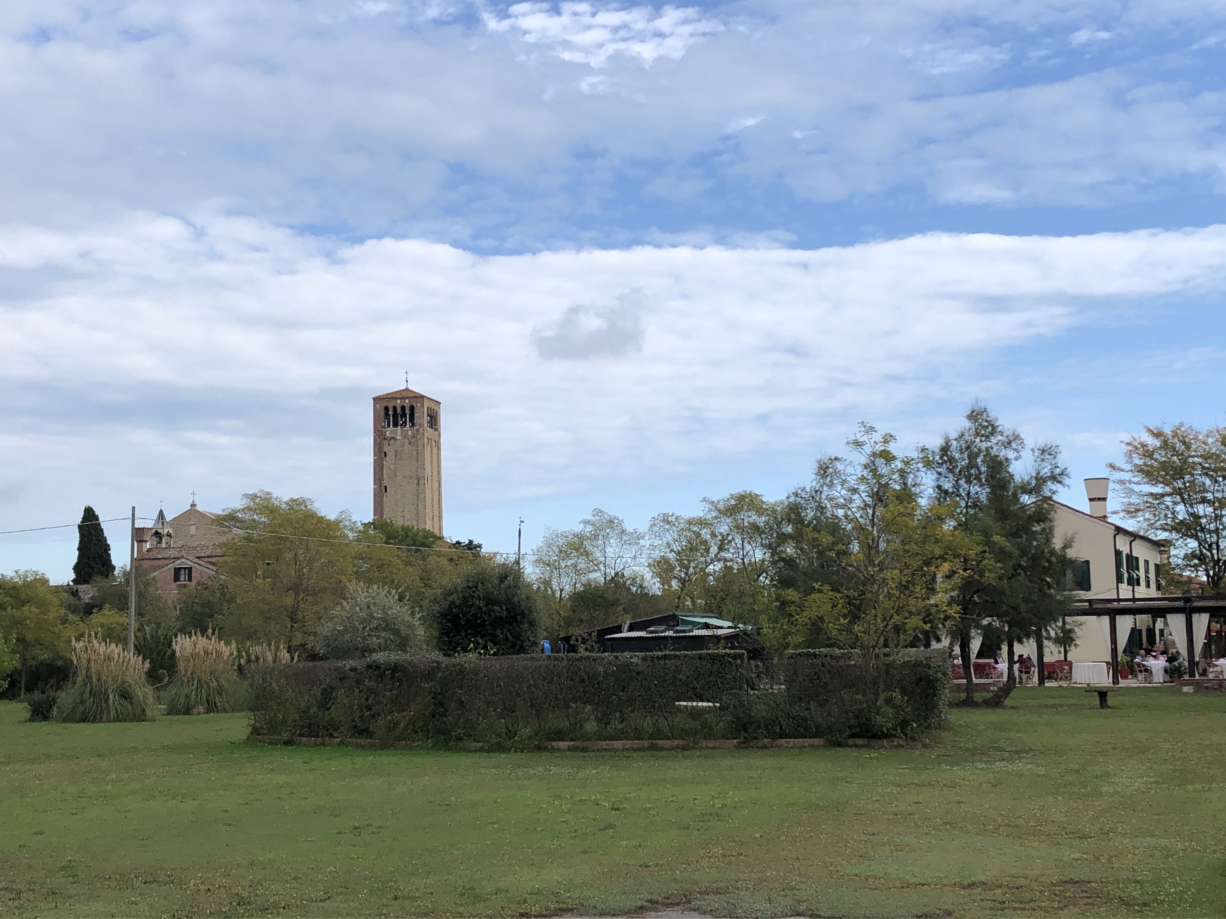 The Basilica of Torcello, surrounded by gardens.