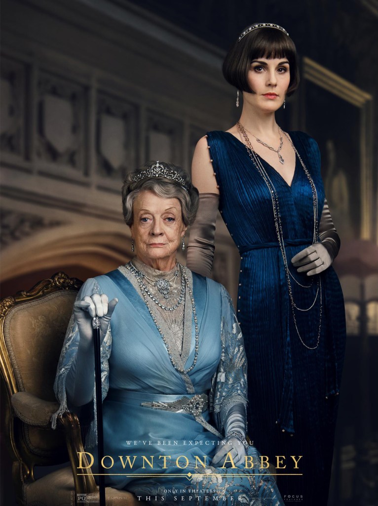 Lady Mary wears a navy blue, pleated silk 'Delphos' gown inspired by 'Fortuny' design. Downton Abbey (2019)